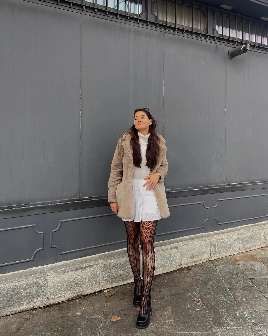 Brown button-up shirt with white relaxed pants and brown bag