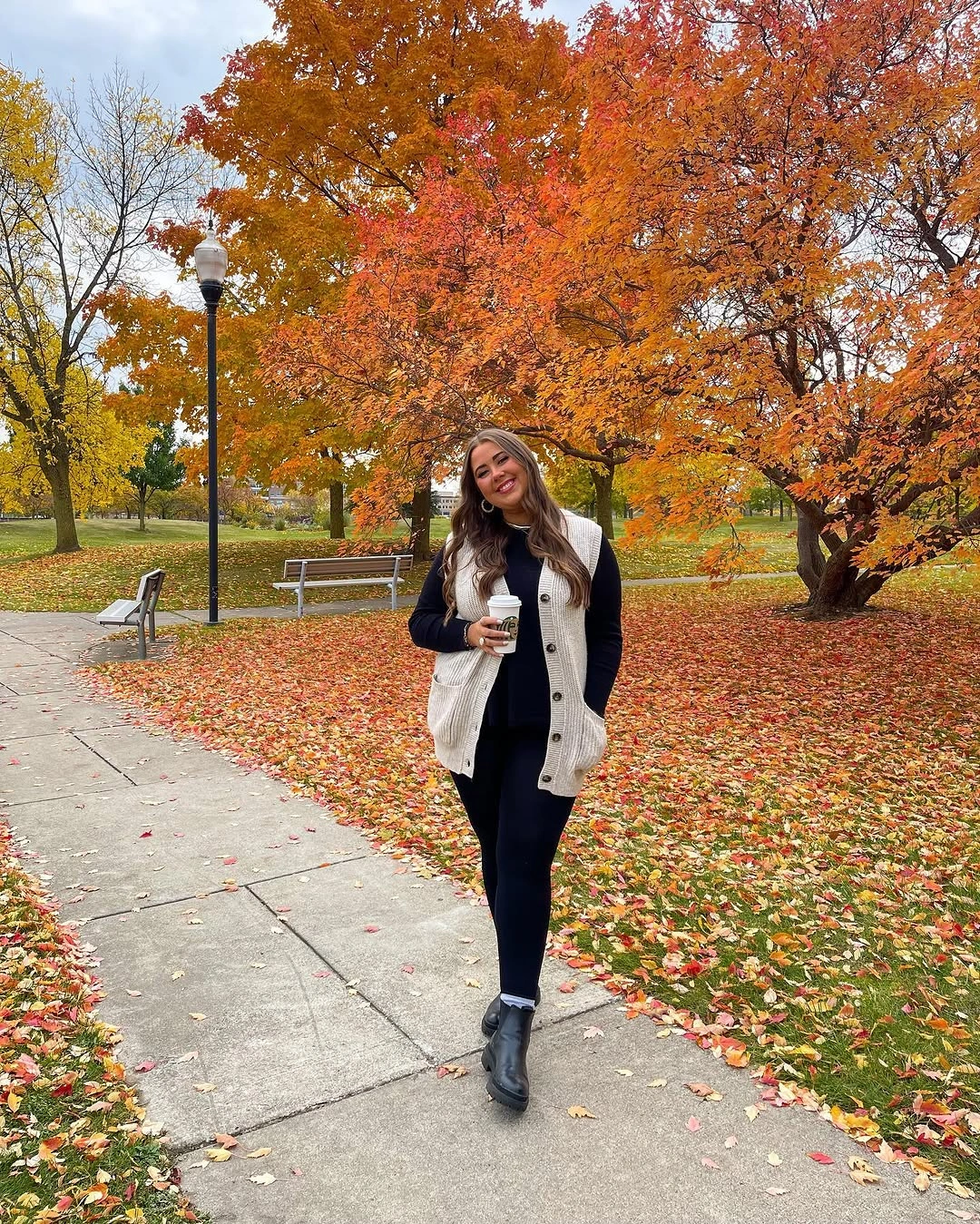 Dark jacket with white top dark jeans and casual shoes