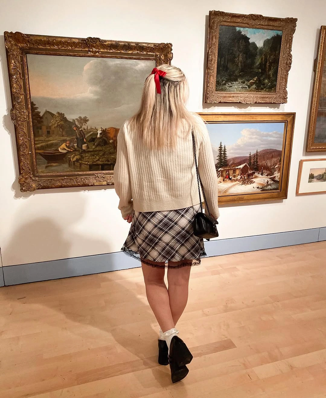 Beige cardigan with plaid skirt and black ankle boots