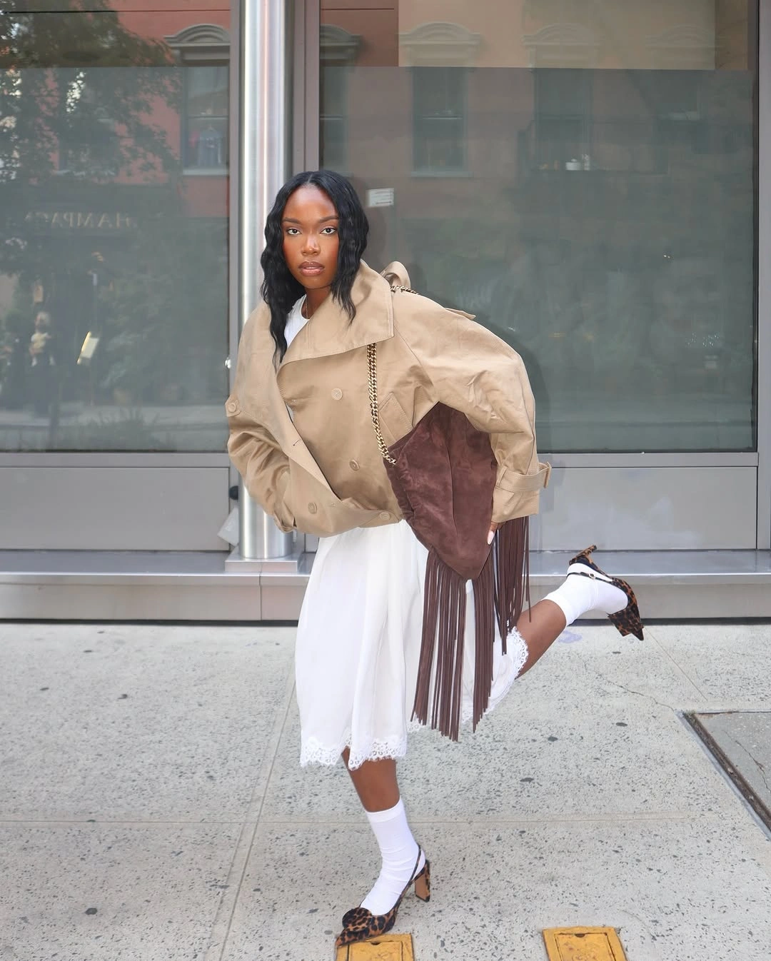 Beige cropped jacket with white skirt brown bag and flats