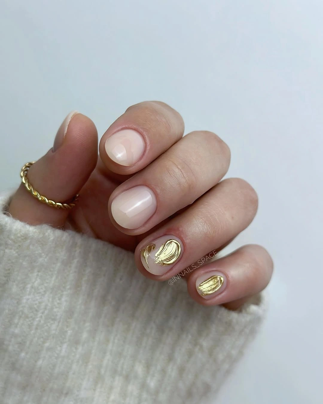 Short rounded square milky pink nails with tiny warm oval accents
