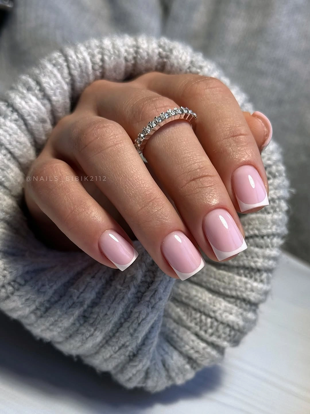 Short squoval nails in a glossy soft baby pink color