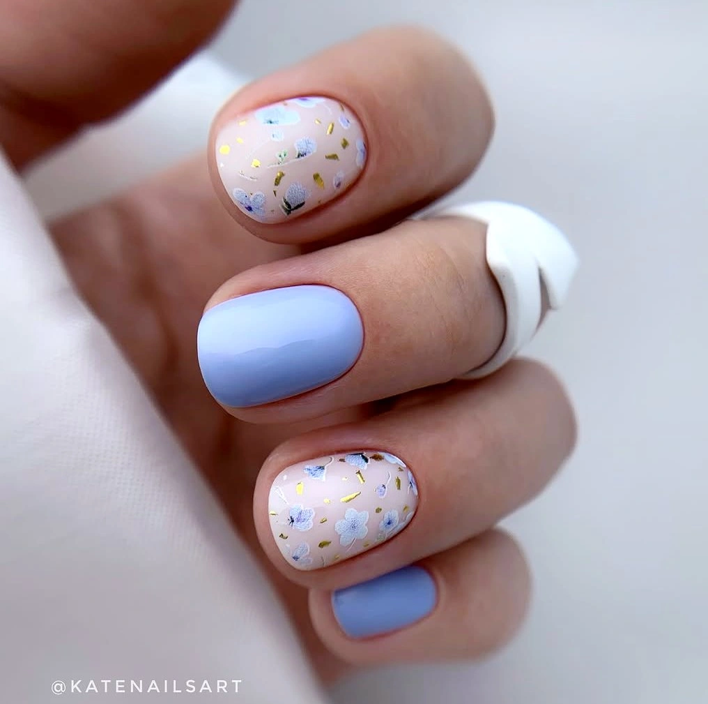 Short square powder blue nails with colorful dotted white accents
