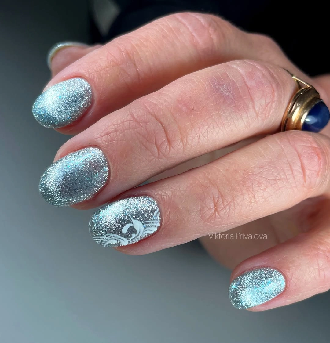 Short oval nails with an even icy silver sparkle finish