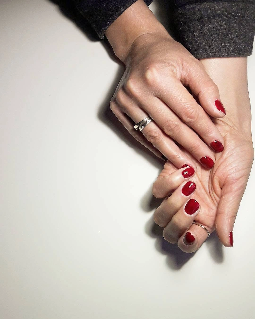 Short square nails in a deep glossy cherry red color