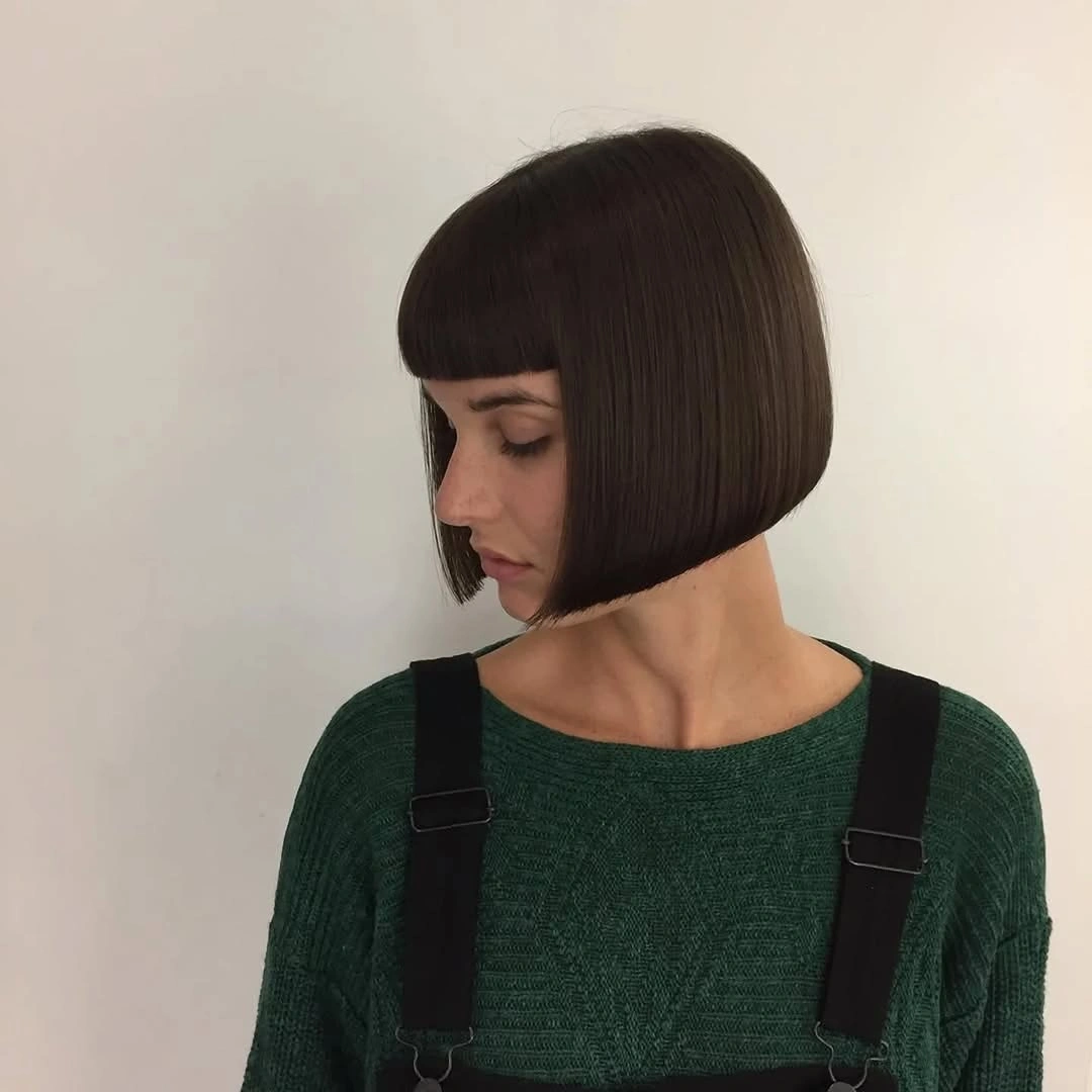 Dark short bob with blunt bangs and rounded sides