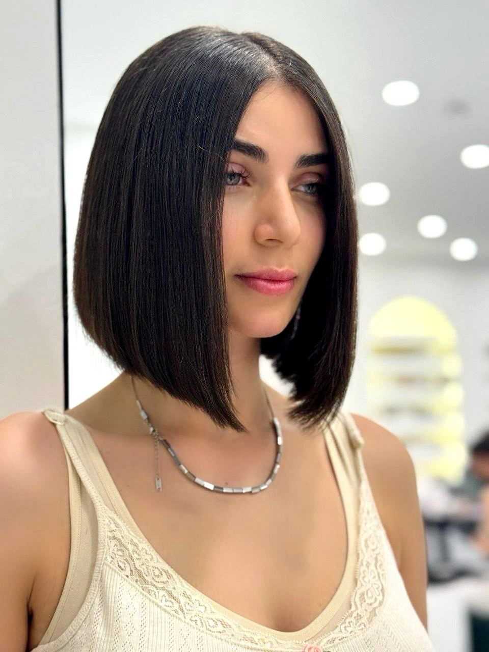 Sleek dark bob with center part and angled front