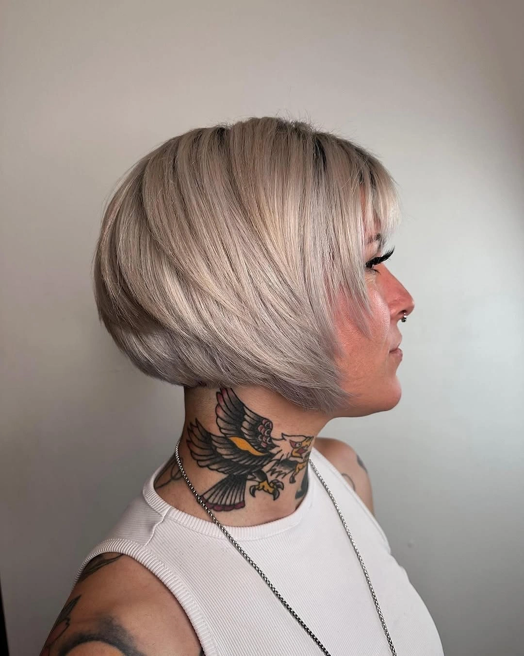 Pale blonde stacked bob with rounded nape and side sweep