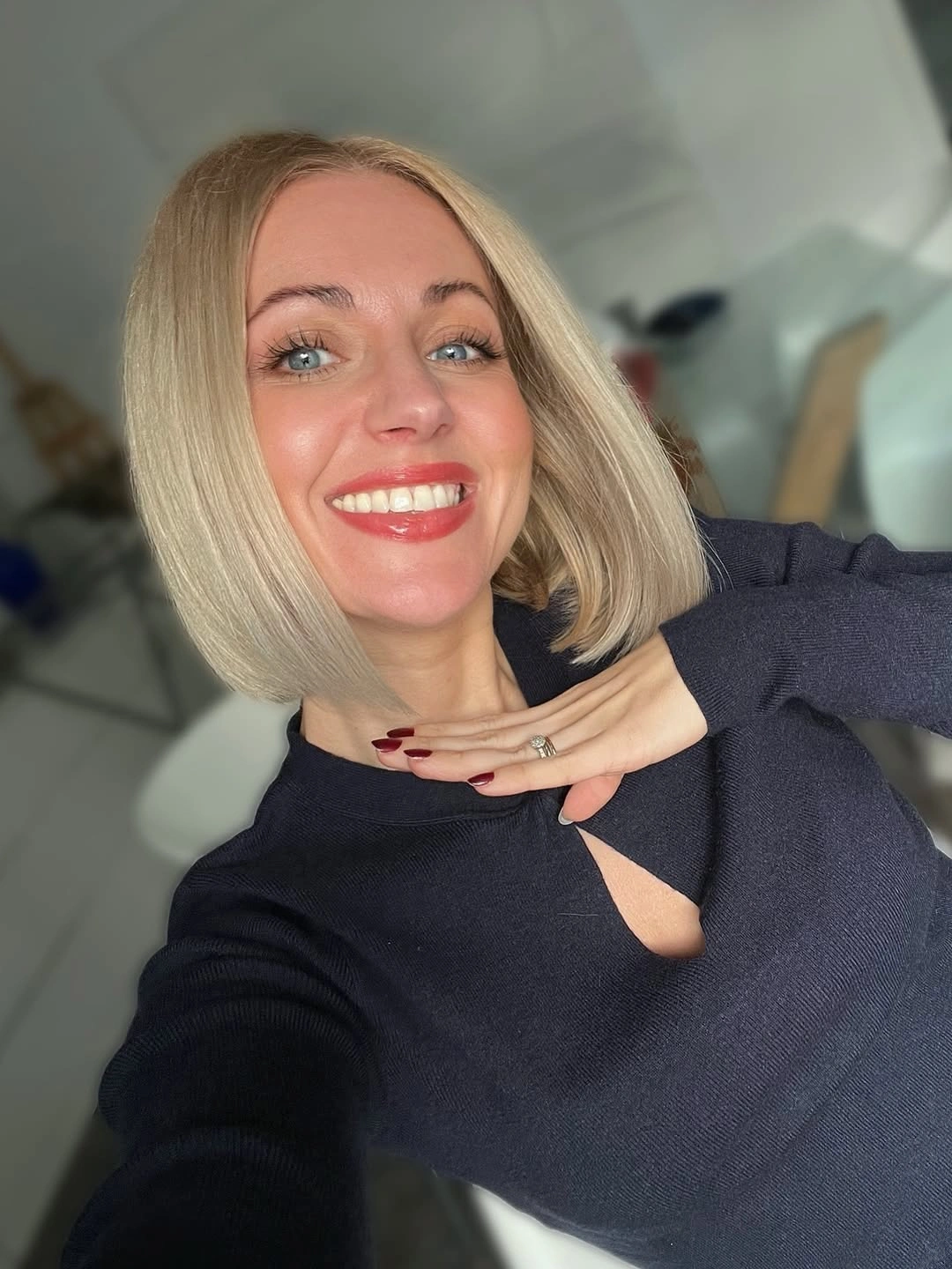 Smooth blonde bob with center part and curved ends