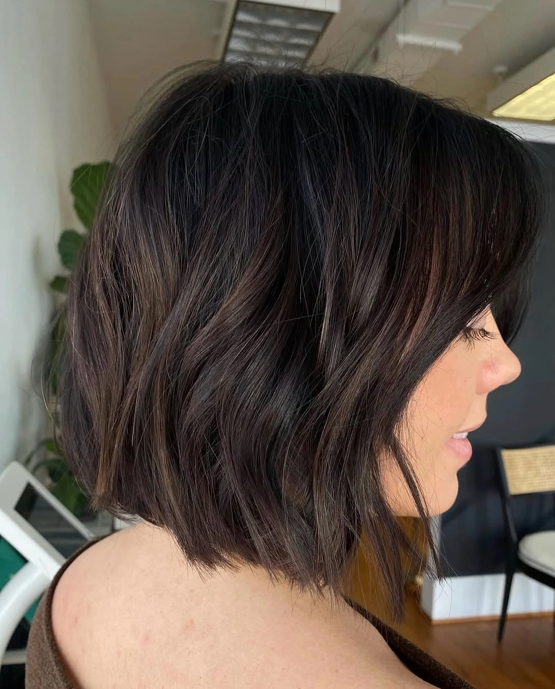 Dark wavy side-view bob with airy neck-length ends