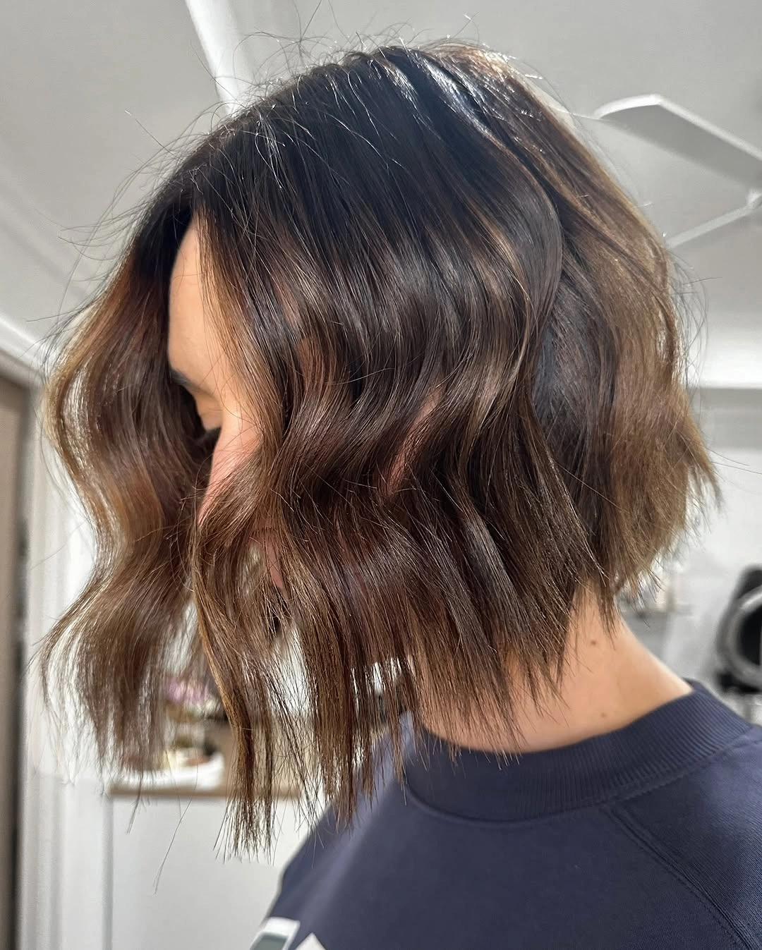 Wavy brunette bob with lighter face-framing pieces