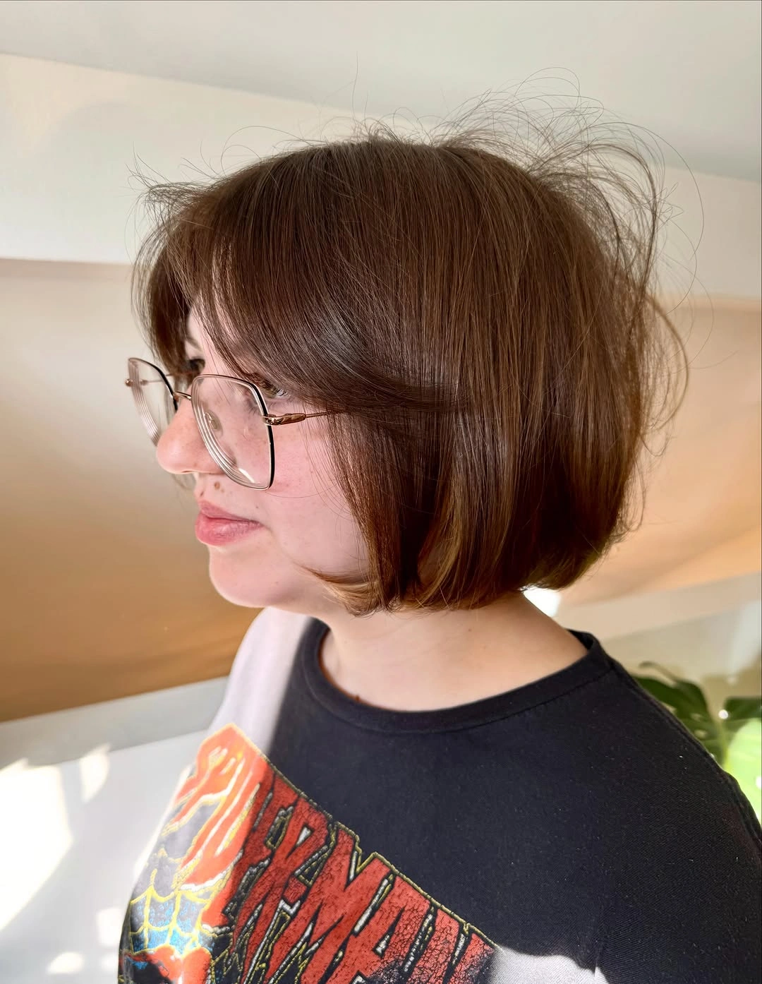 Warm brown rounded bob with soft bangs and glasses