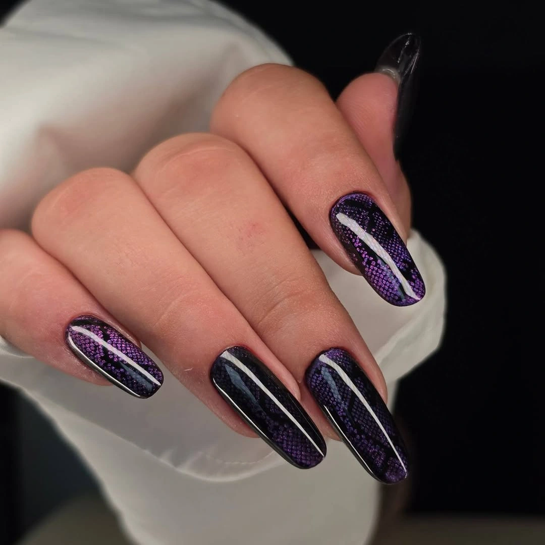 Long pointed almond nails with black purple texture and diagonal pale stripes