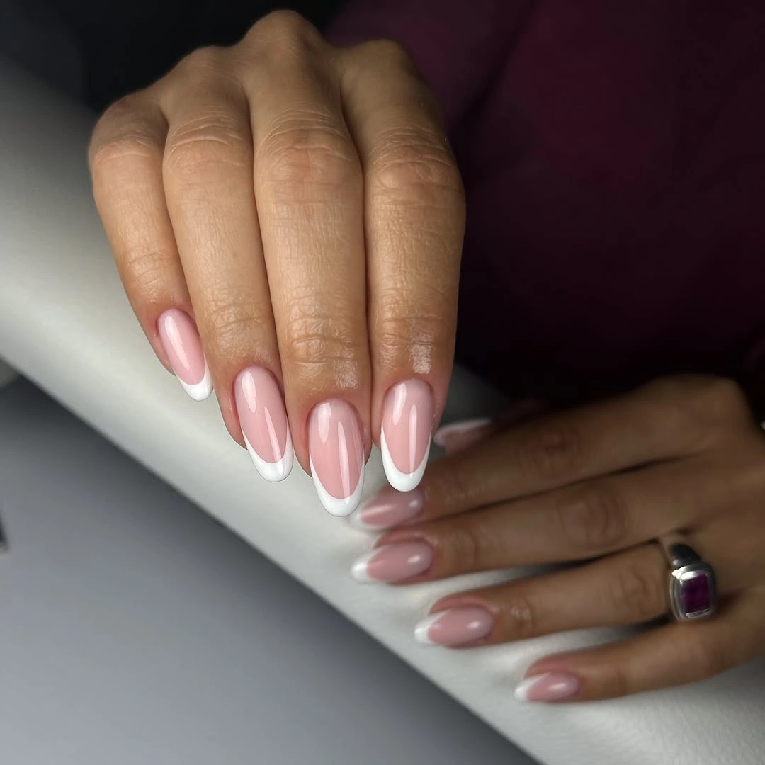 Medium almond nails with sheer pink base and white French tips