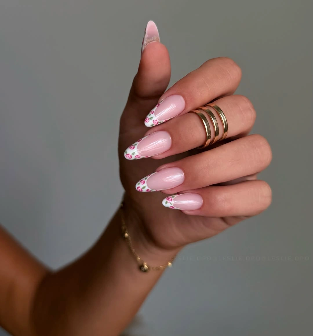 Long almond nails with pale pink base and tiny floral French tips