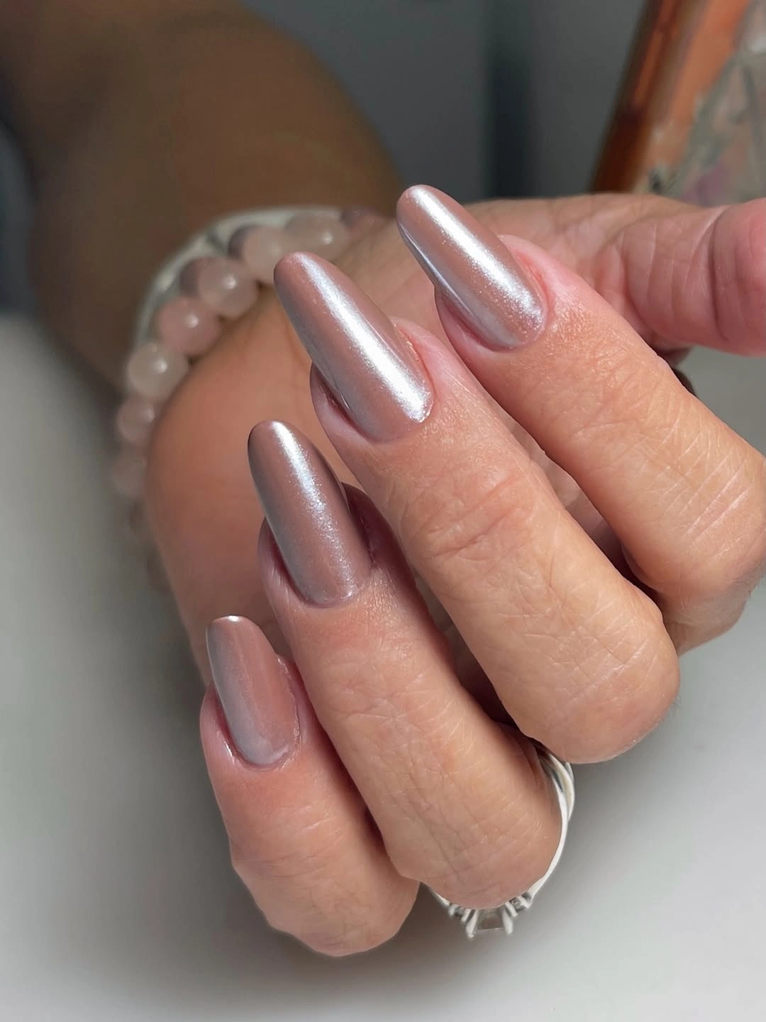 Medium-long almond nails with pearly silver-lavender sheen and smooth glossy surface