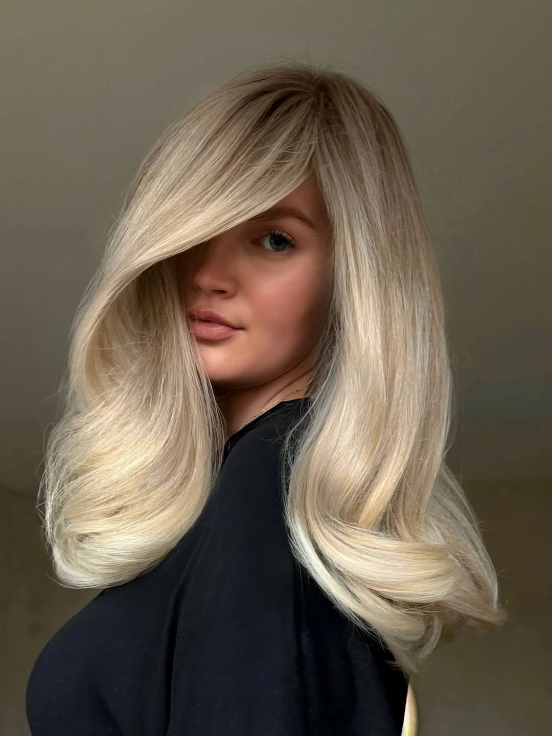 Medium-length pale blonde hair with side-swept front section