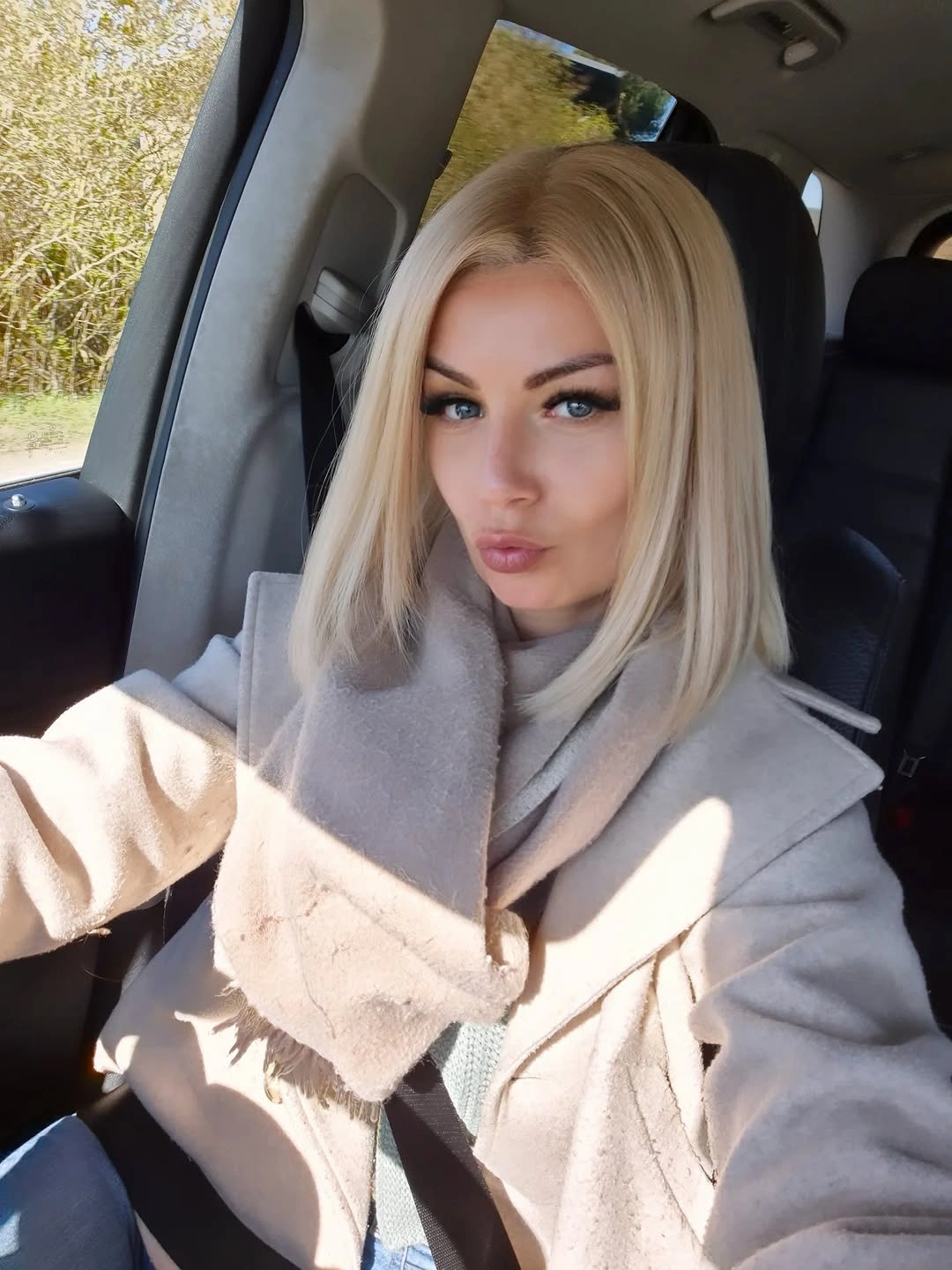 Straight pale blonde bob with center part and soft root depth