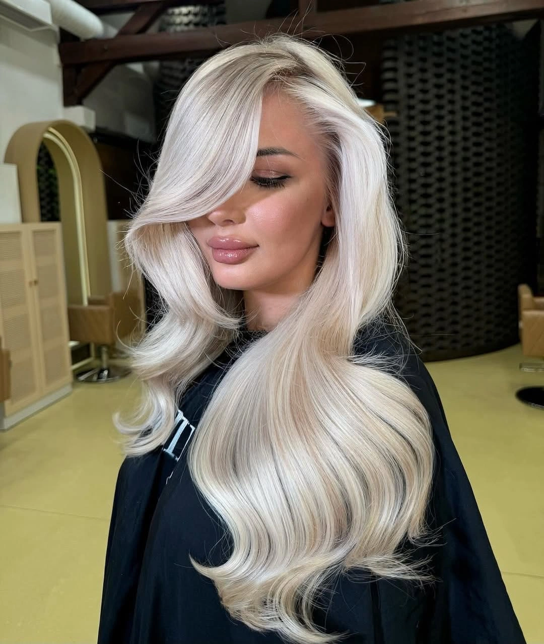 Extra-long icy blonde hair with side sweep and broad waves