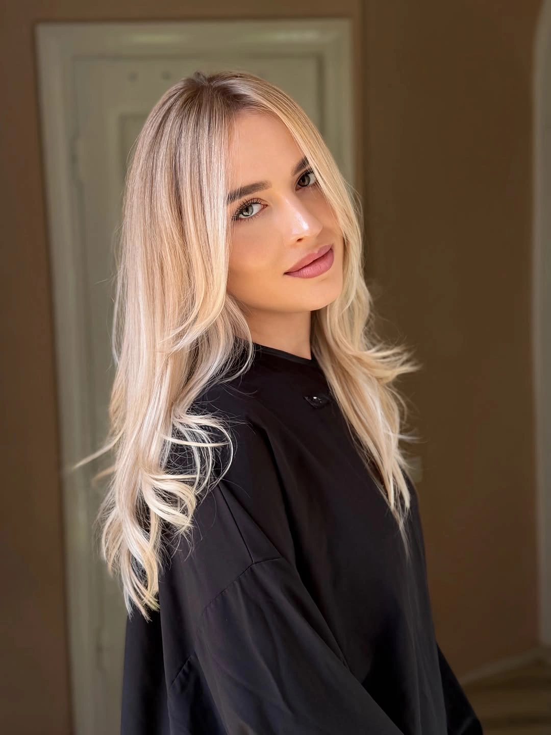 Long champagne beige blonde hair with softly flipped layered ends