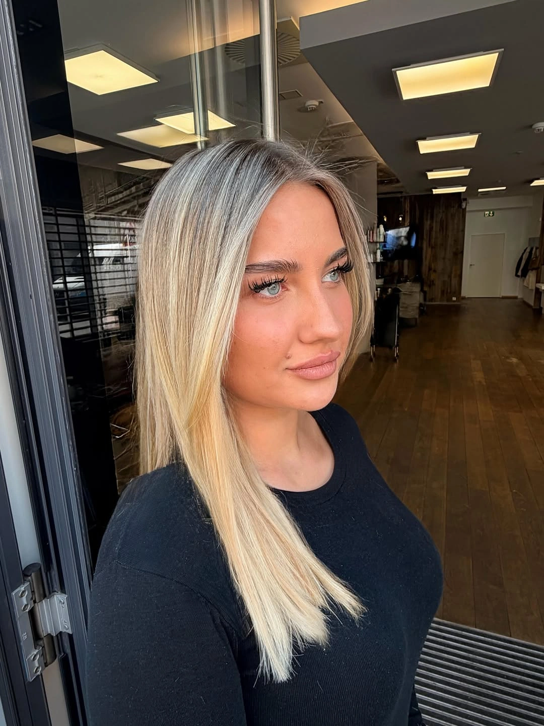 Long straight cool blonde hair with deeper smoky roots