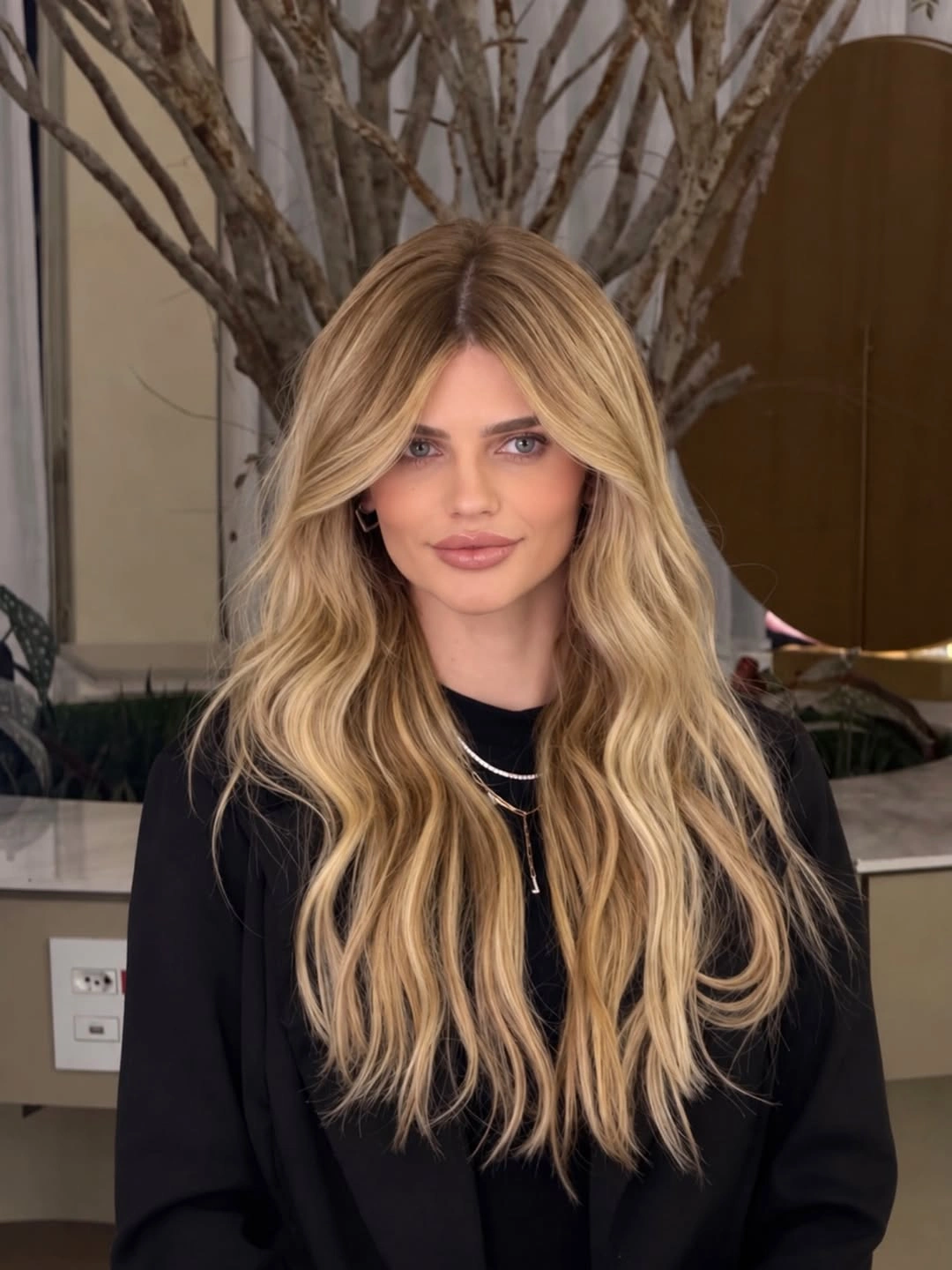Very long warm beige blonde waves with deeper roots