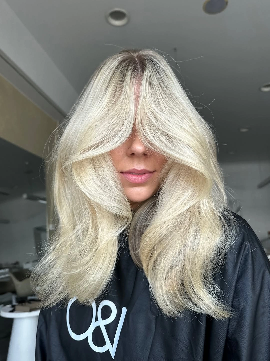 Voluminous pale blonde hair with long face-framing layers
