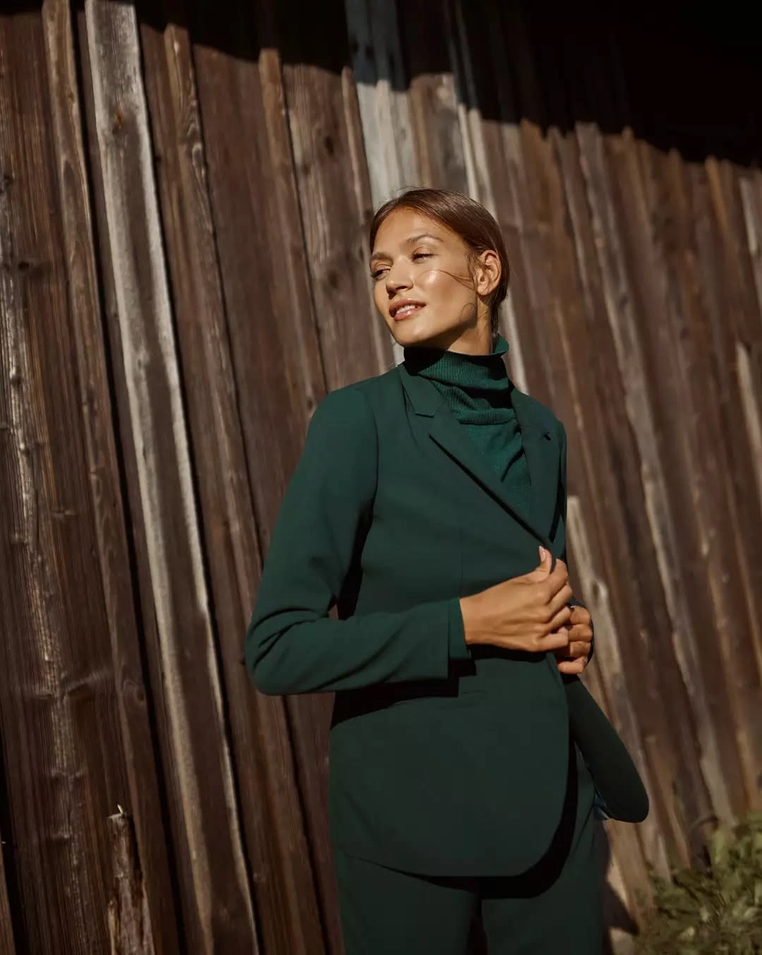 Deep green high-neck top with tonal jacket and lower piece