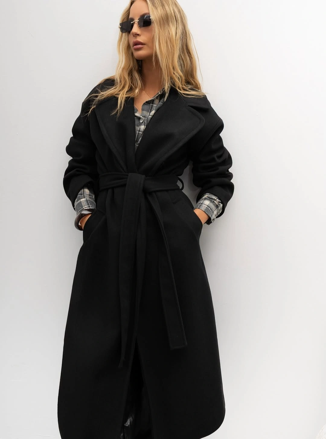 Long black belted layer over gray checked shirt