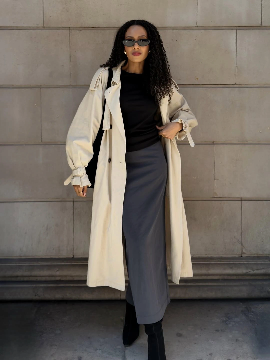 Cream long outer layer over black top and gray skirt