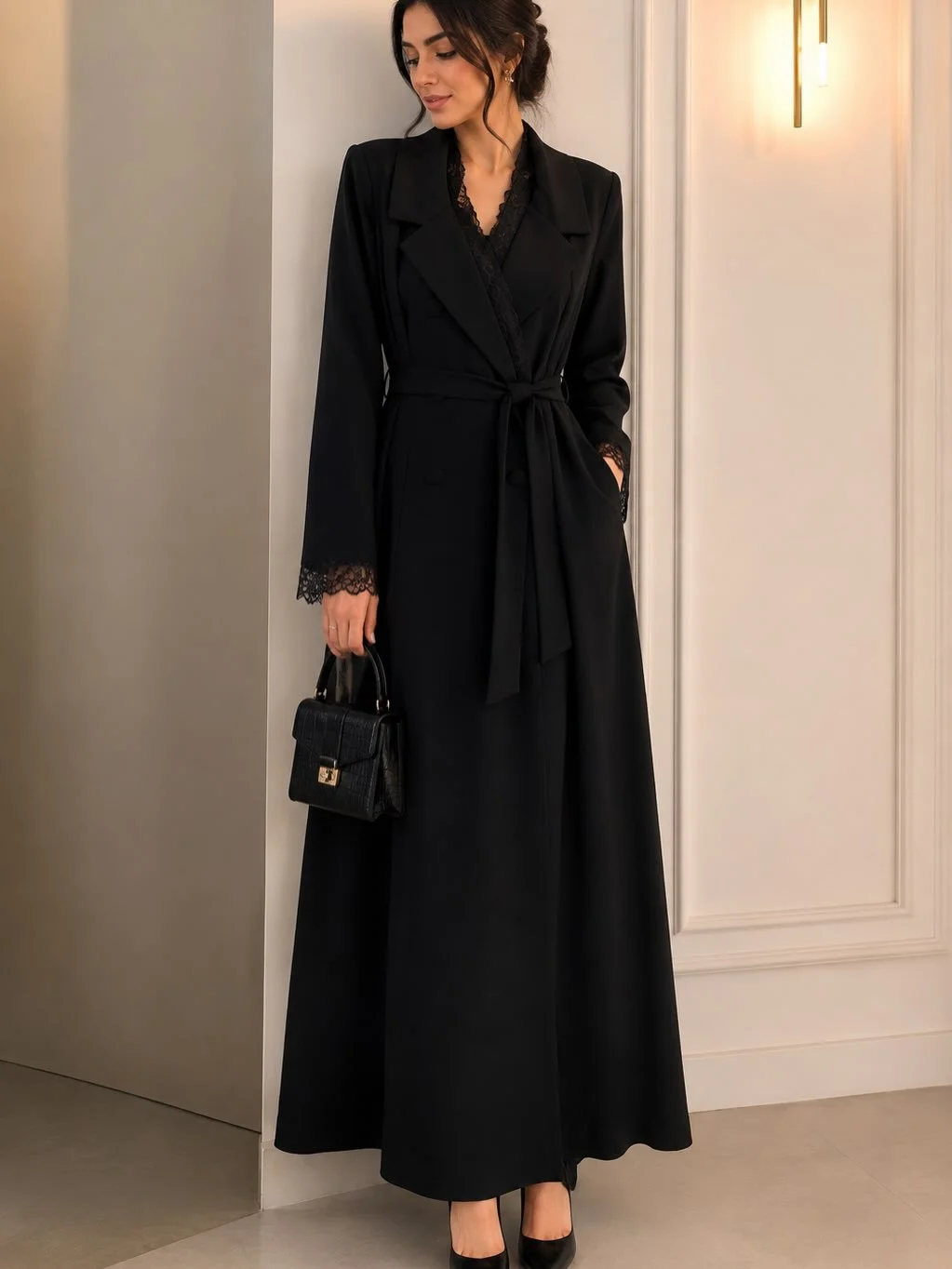 Long black wrap-style layer with tied waist and small handbag