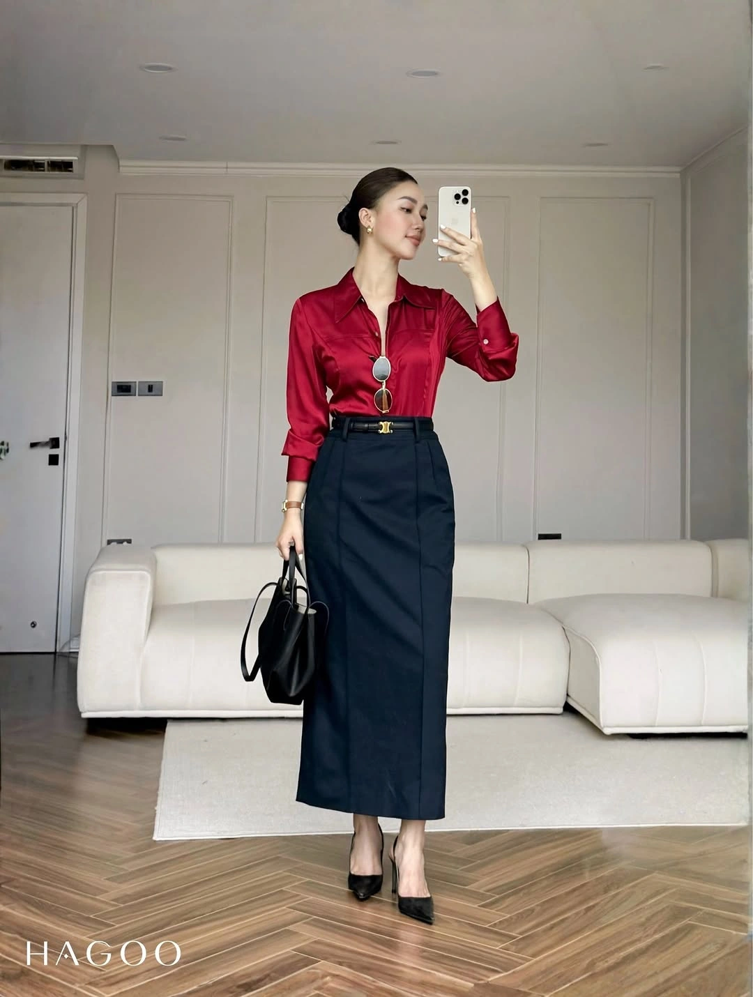 Red button-up shirt tucked into dark midi skirt