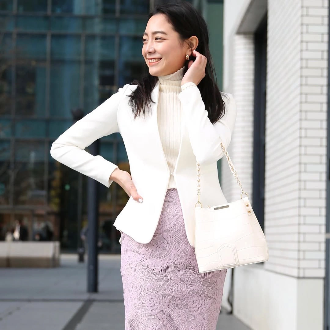 White fitted jacket with pale pink patterned skirt