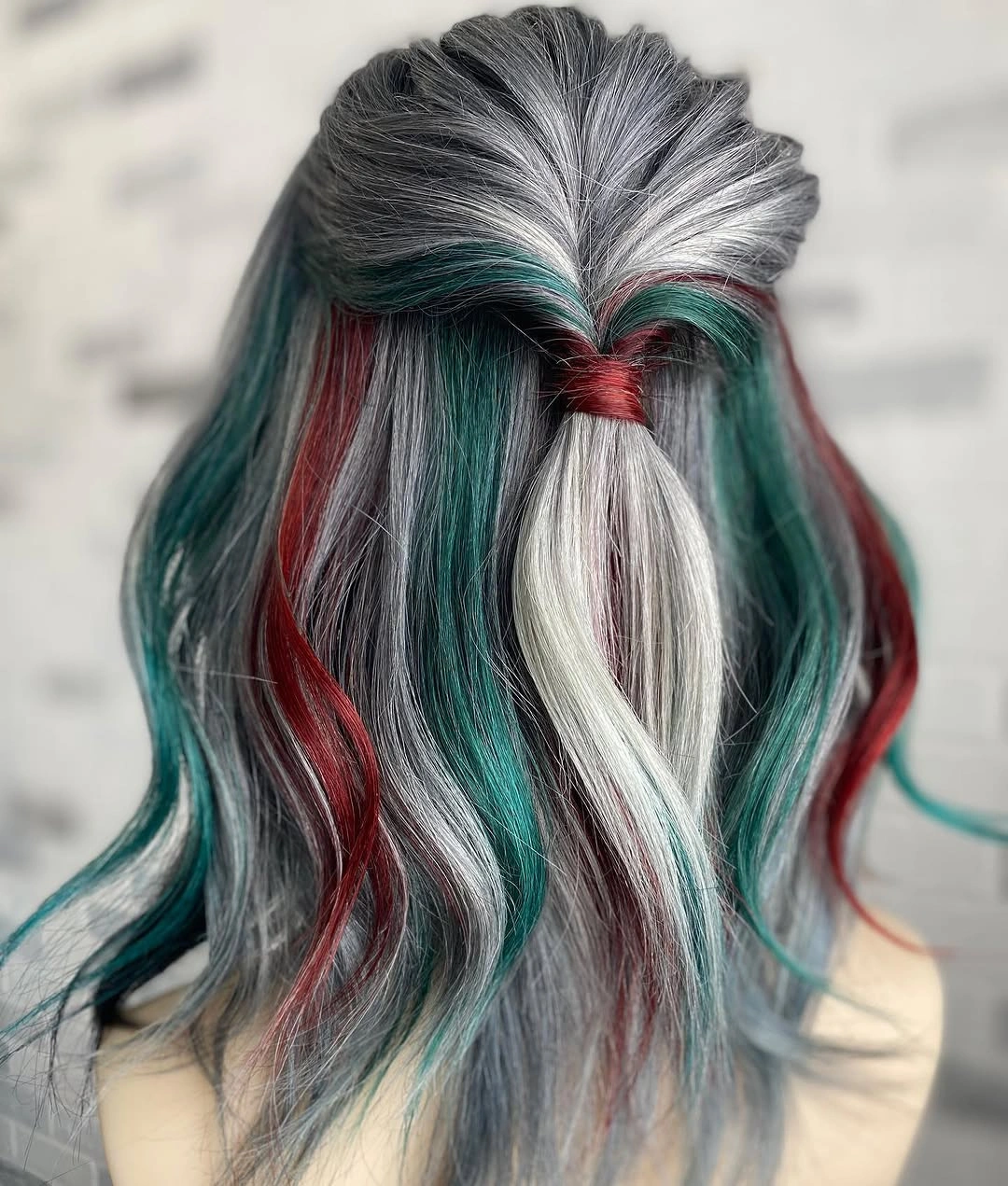 Silver-gray half-up hair with red and green sections