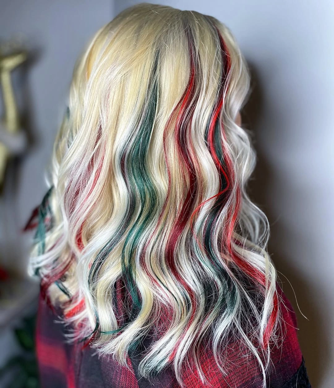 Long pale blonde hair with narrow red and green streaks