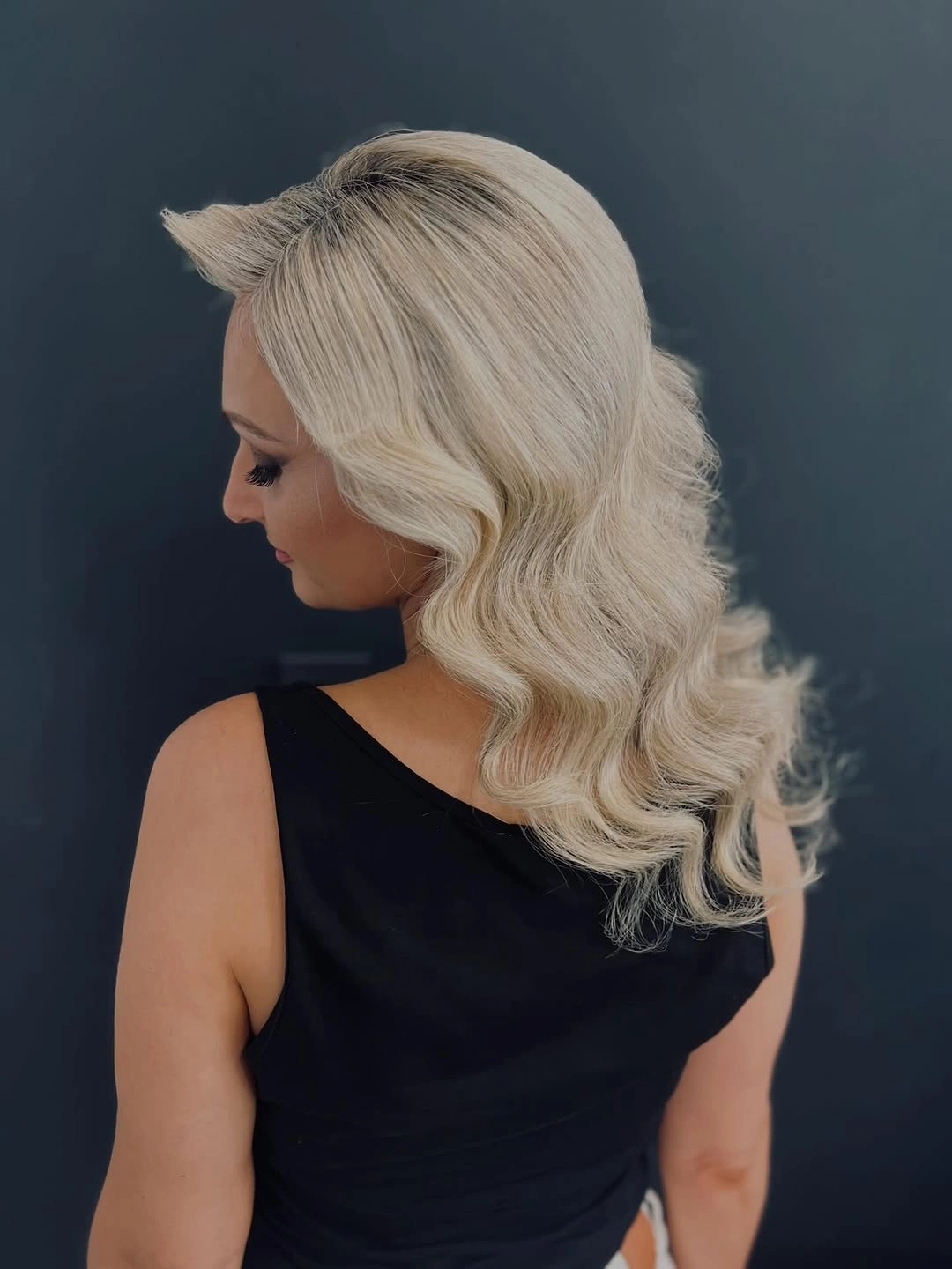 Pale blonde hair with side sweep and large smooth waves