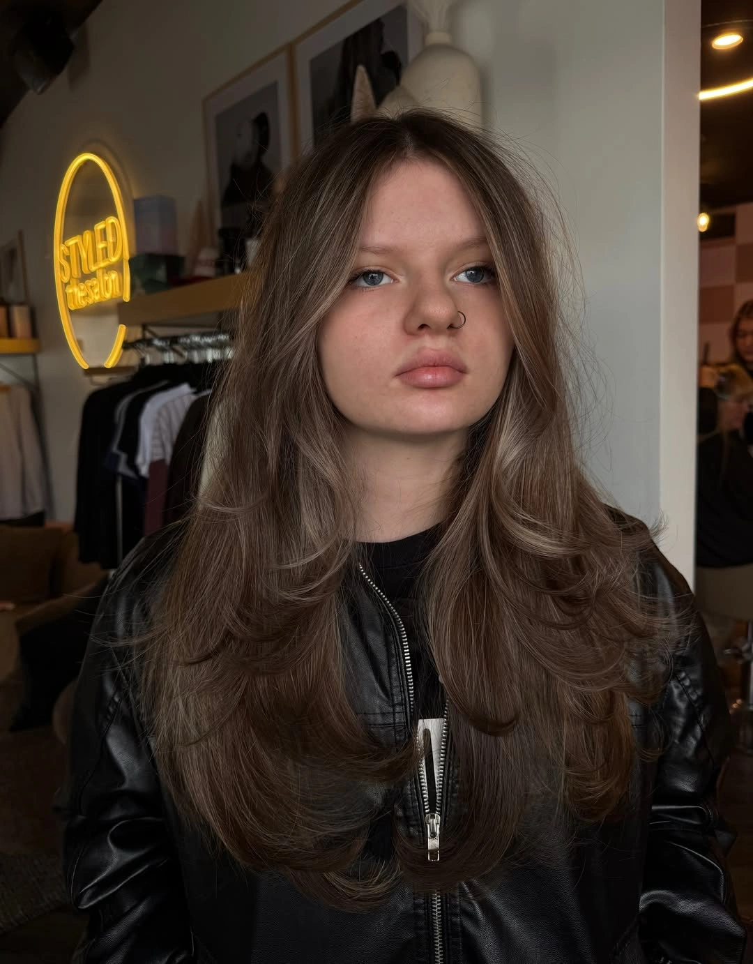 Long chestnut-brown hair with center part and rounded face-framing layers