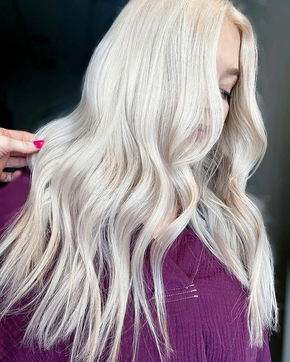 Very long near-platinum hair with center part and open waves