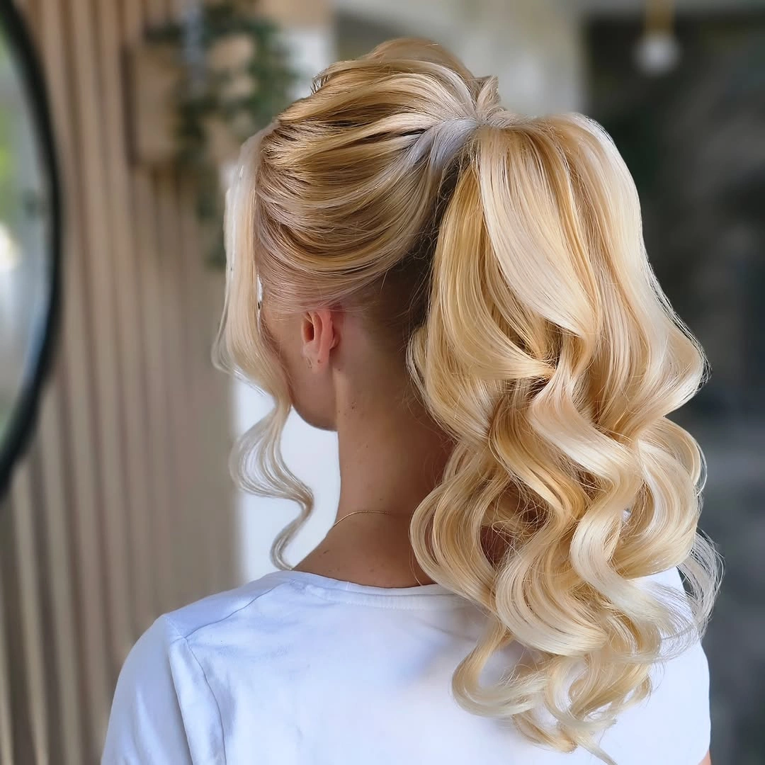 Blonde high ponytail with lifted crown and curled lengths