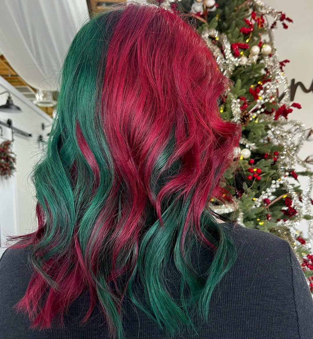 Red and green hair with large waves beside decorated Christmas tree