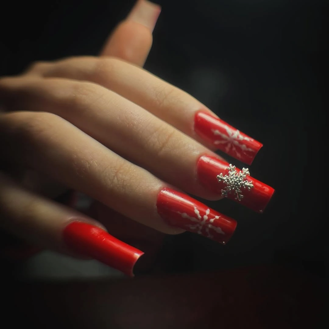 Long red nails with white winter lines and silver snowflake