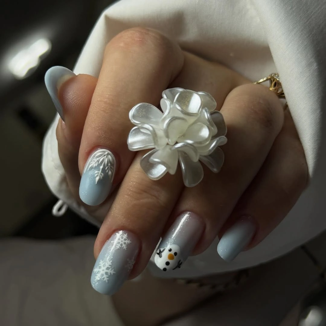 Icy blue nails with white flower snowflake and character accent