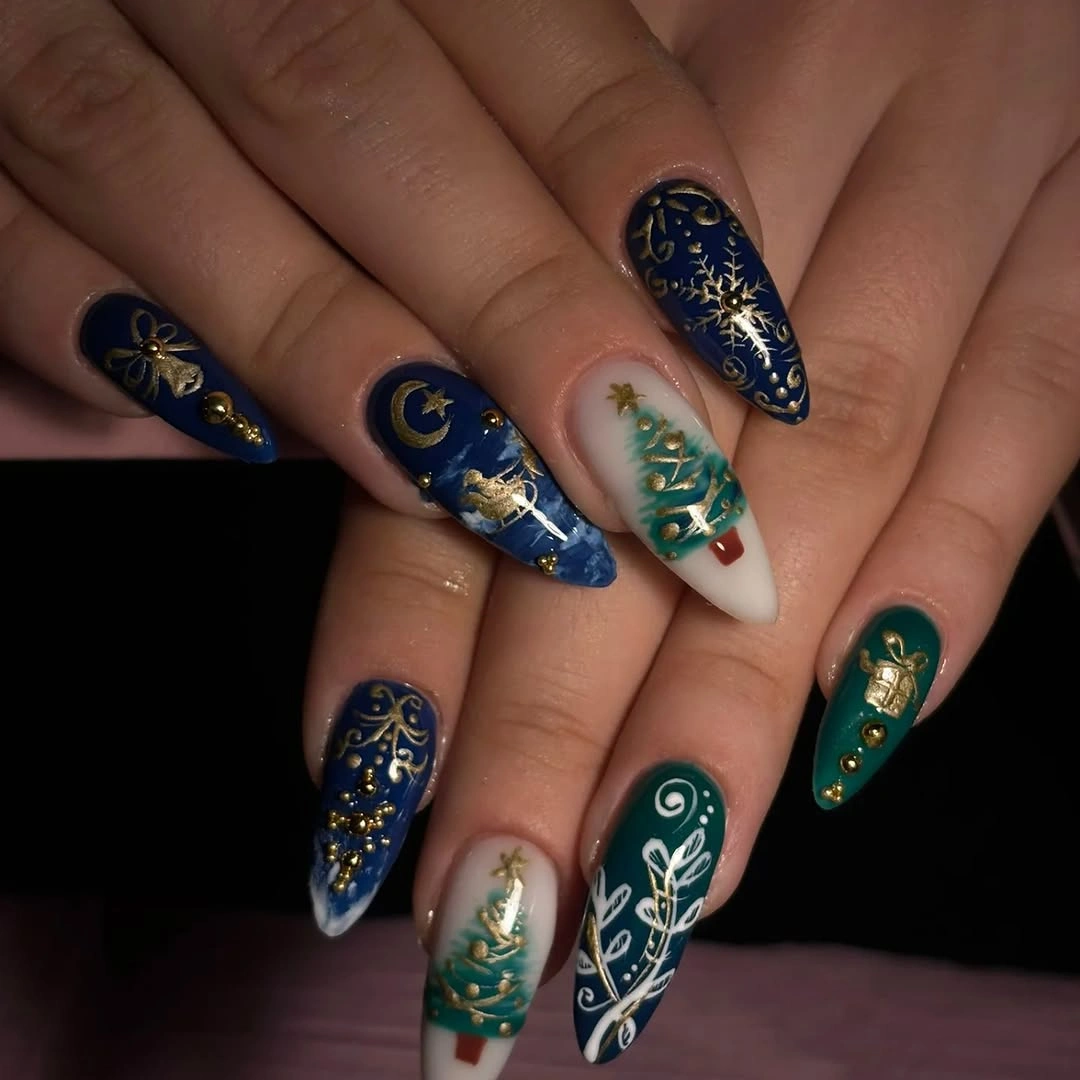 Pointed navy teal nails with gold stars crescent and Christmas tree