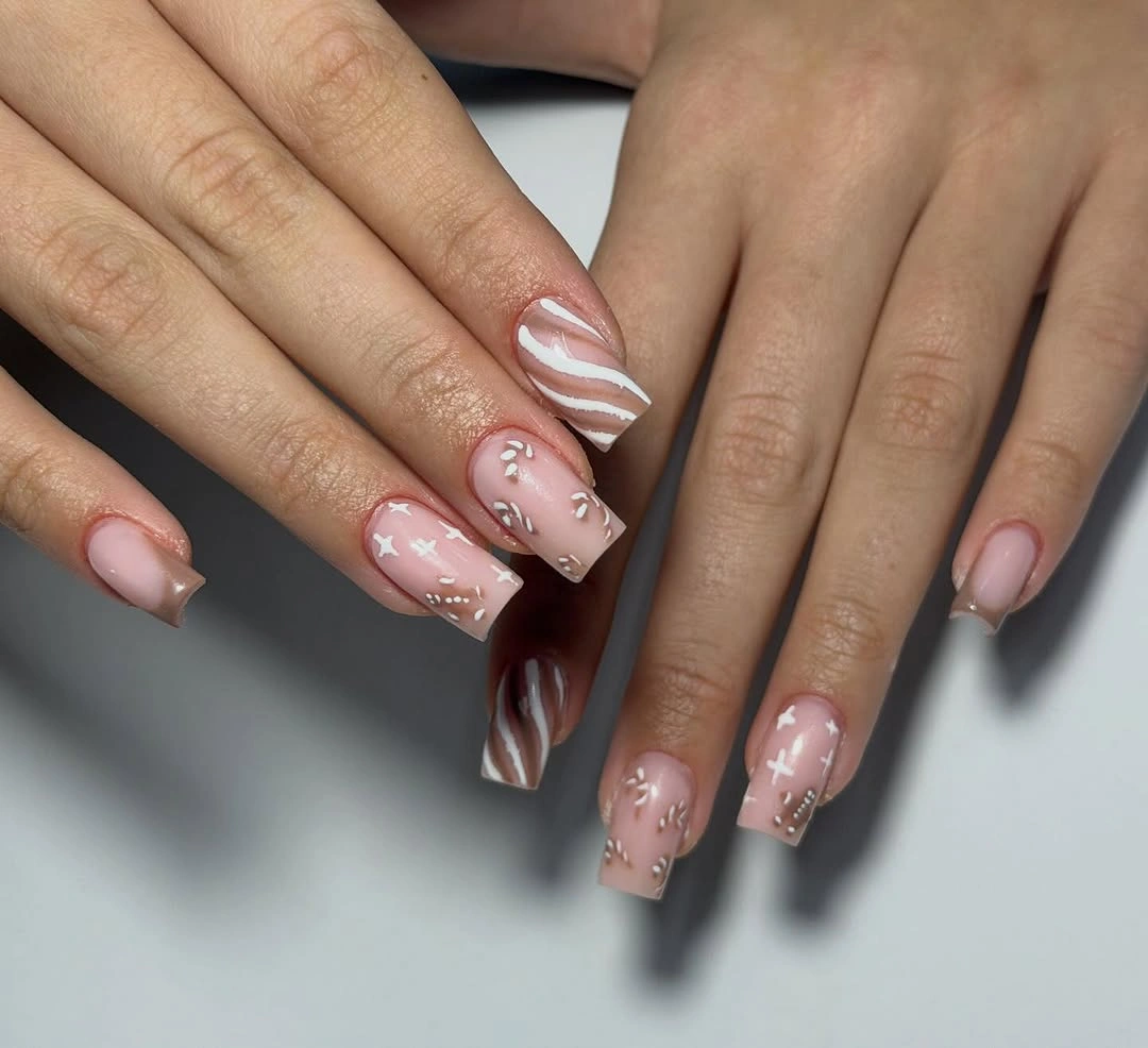 Square nails with pale pink, white curves, and brown waves