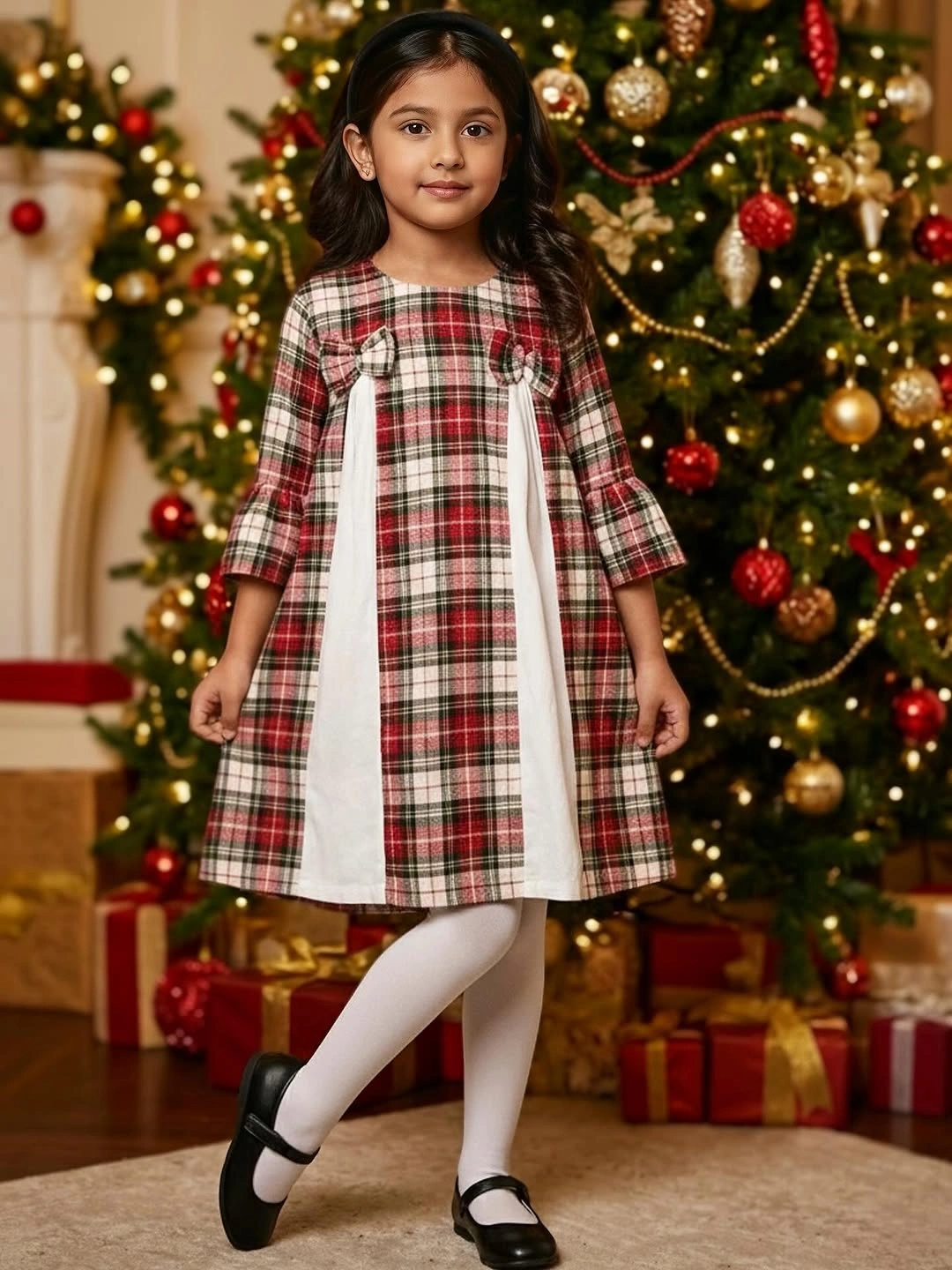 Child in plaid dress with cream panels and white tights