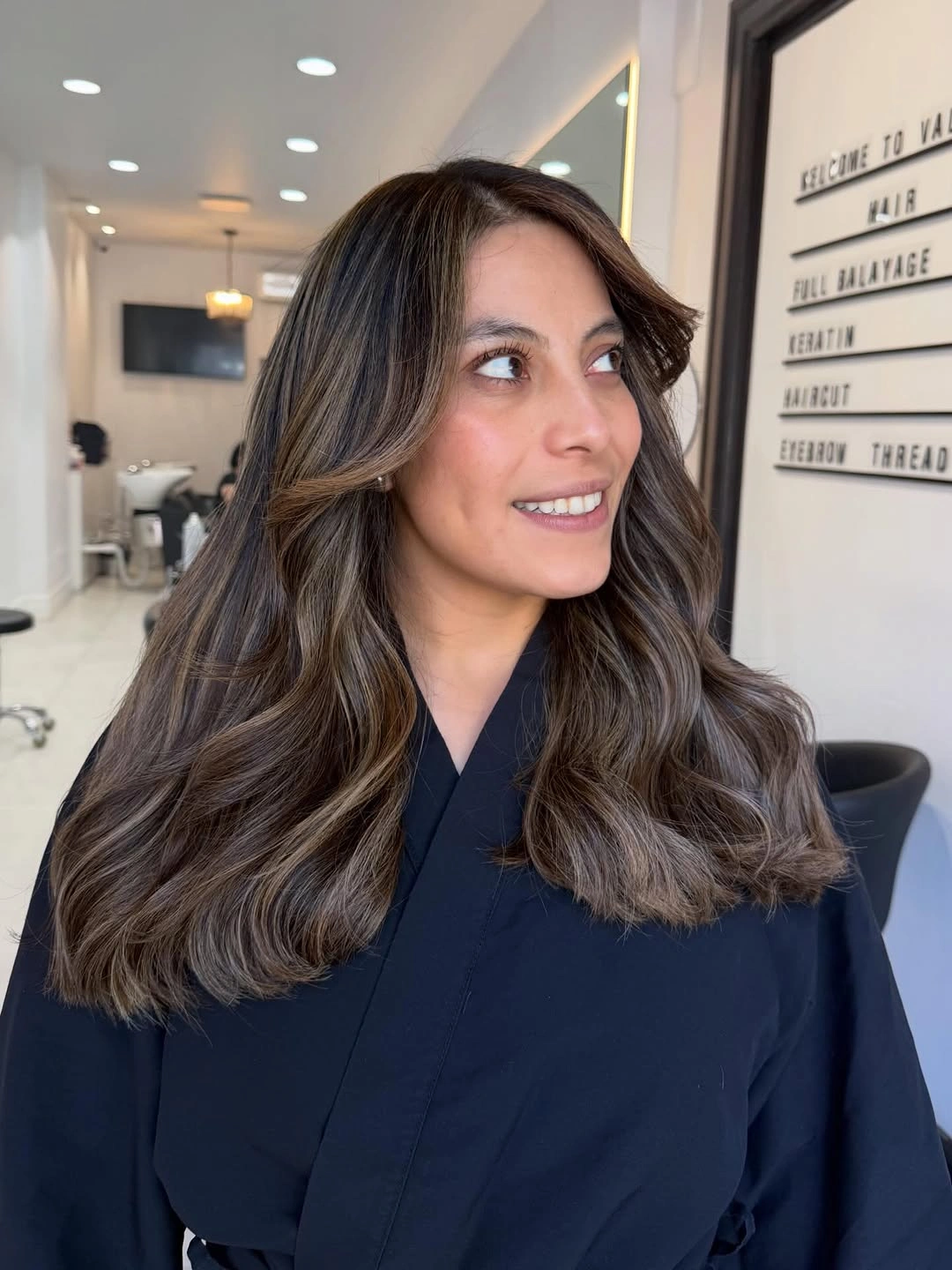 Medium brunette cut with beige face frame and curled ends