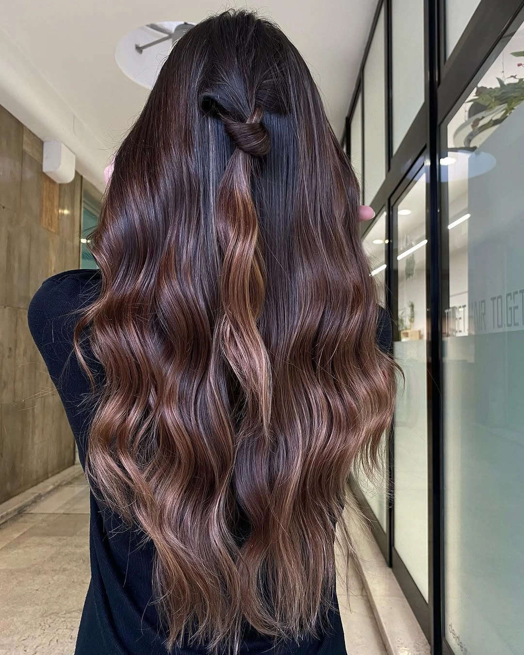 Very long dark brunette hair with half-up twist and plum-copper ribbons