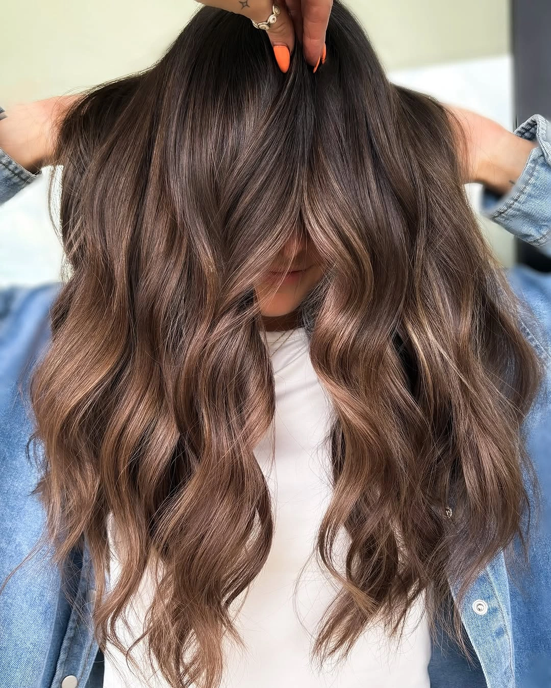 Long brunette waves falling forward with beige caramel ribbons