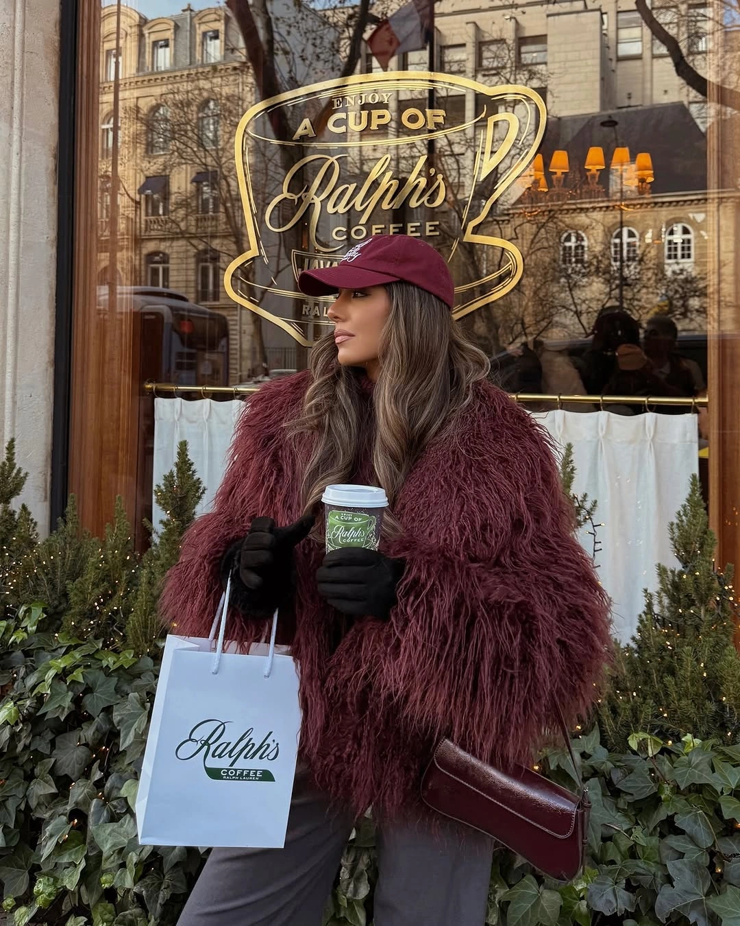 Burgundy shaggy jacket with matching cap, shoulder bag, gray trousers, and gloves
