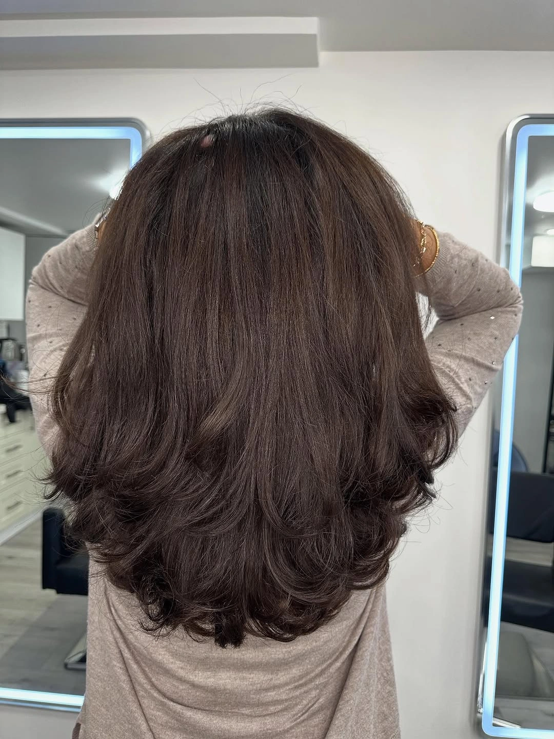 Dark long layered hair with rounded curled ends